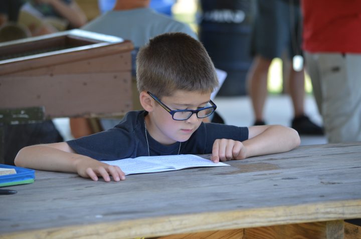Image of young boy memorizing Bible verses