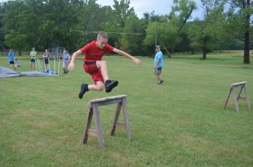 Image of a boy jumping over a hurdle