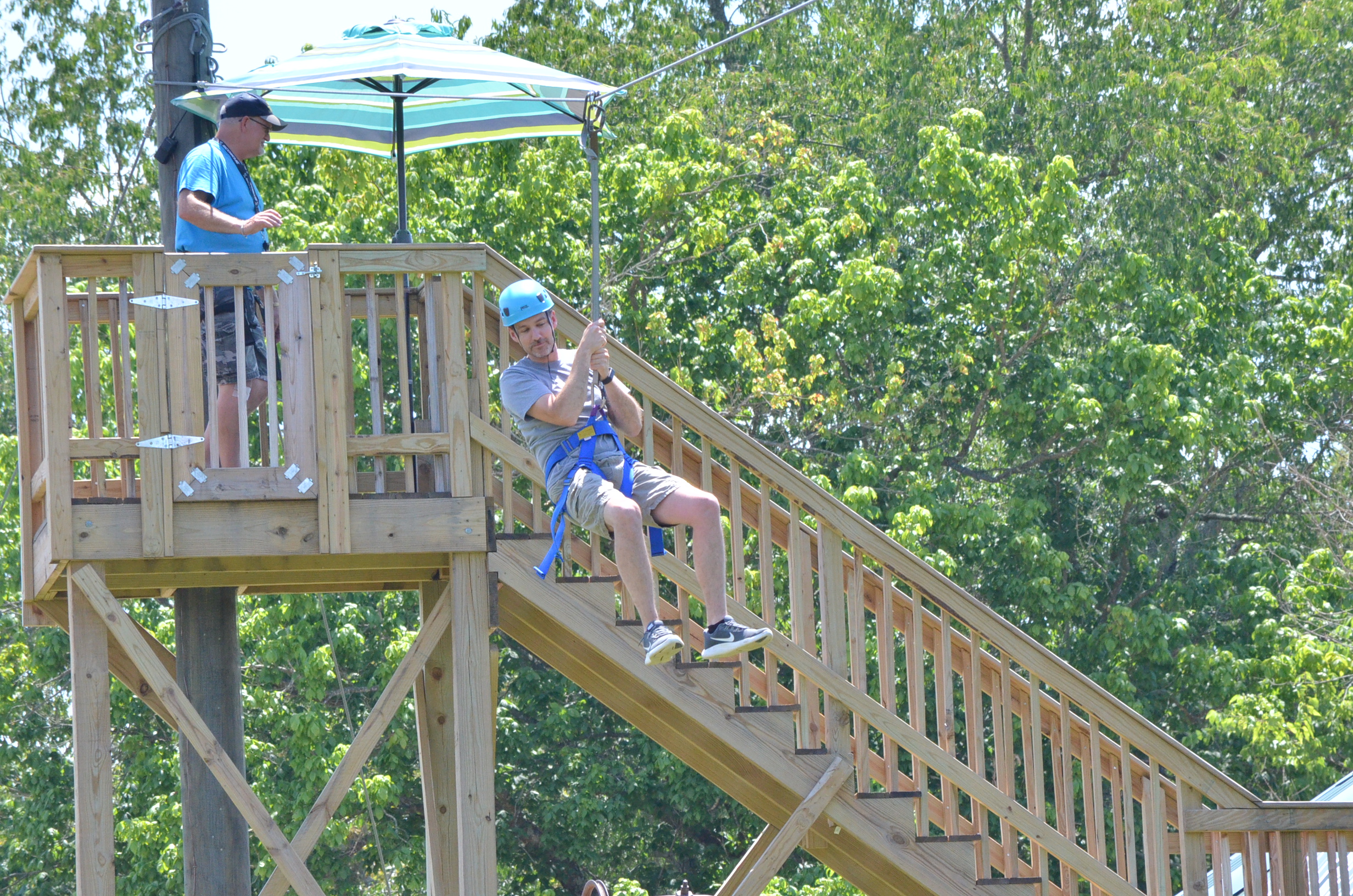 Image of a man going down the zipline