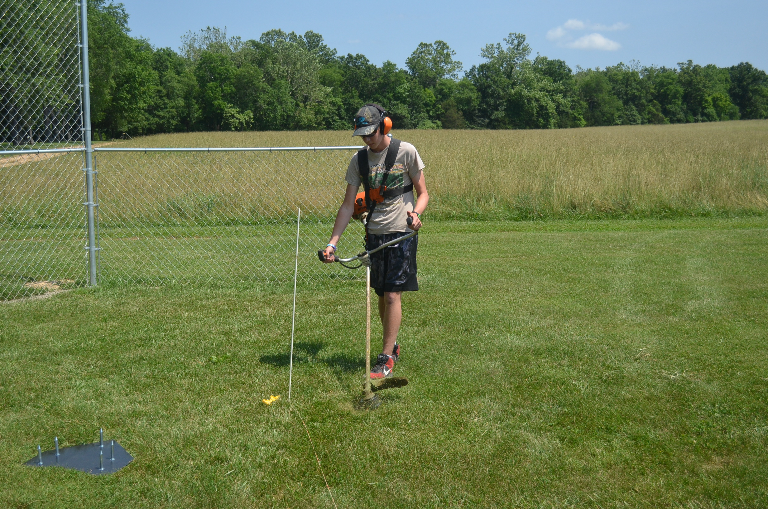 Image of a volunteer using the weed-eater